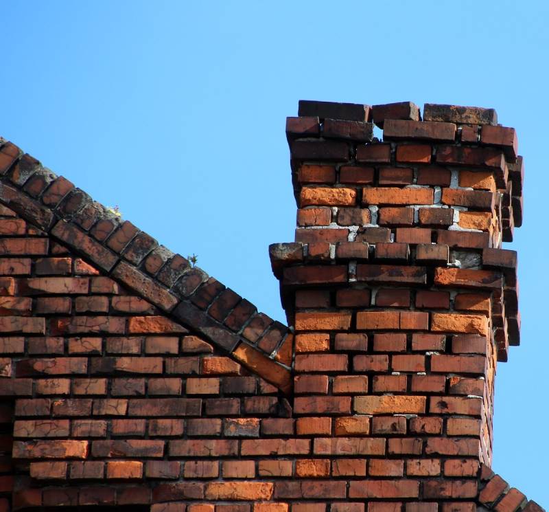Damaged chimney on an Shorewood home showing cracks and missing mortar